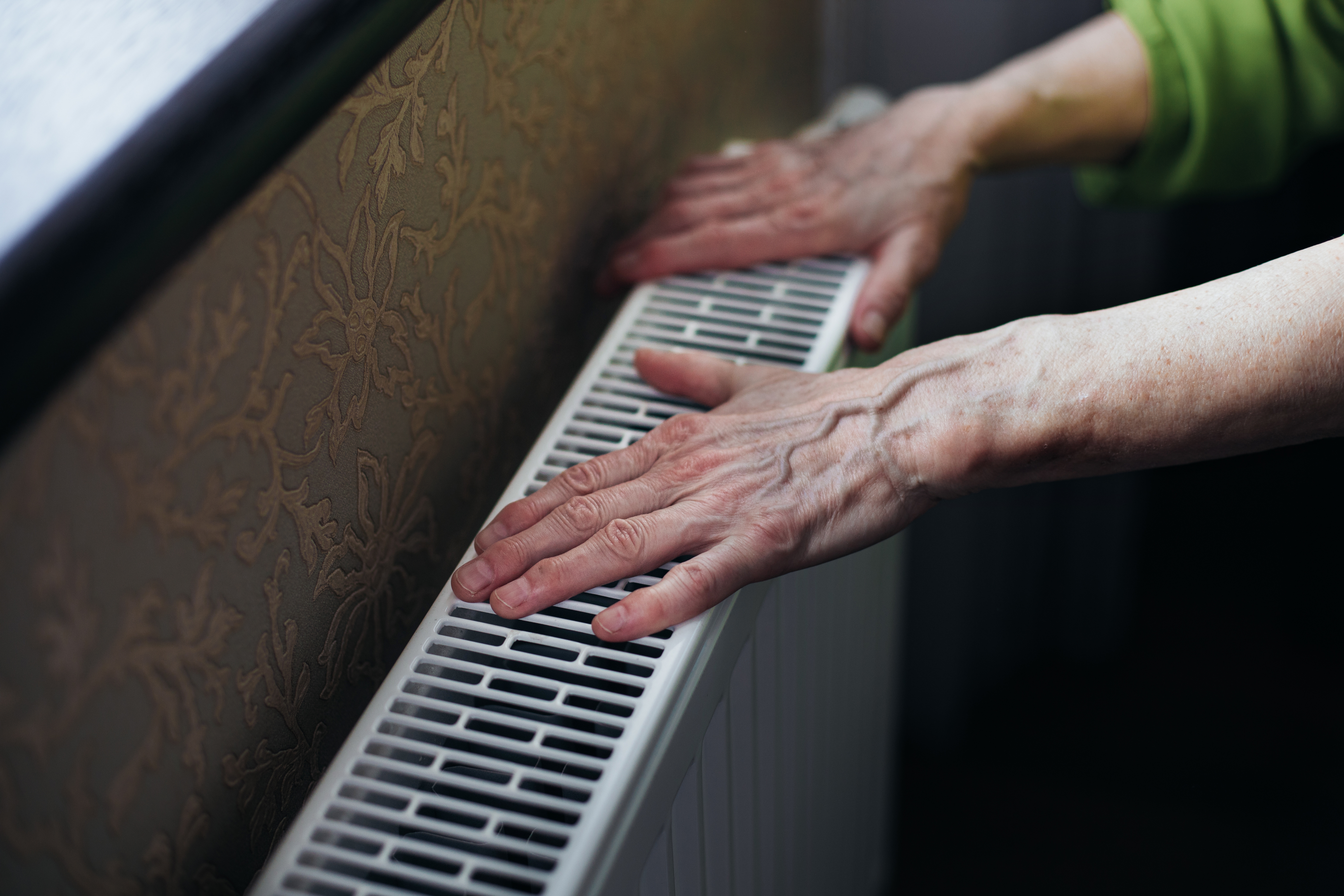 hands touching heater