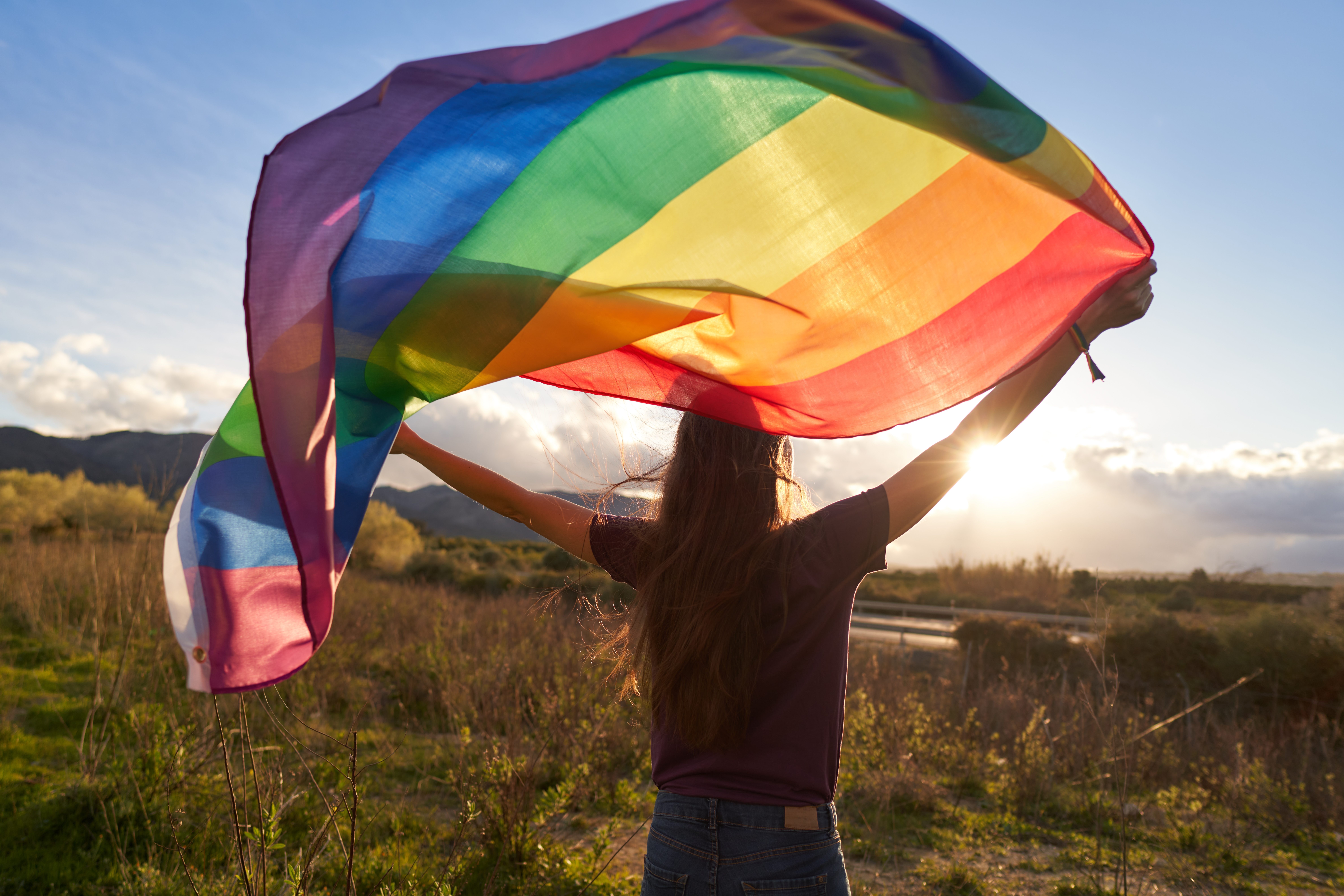 A person carrying rainbow flag 